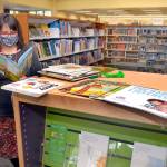 Jennifer Knight, youth services librarian at the Port Angeles Library, looks over a selection of books featured in Dolly Partons Imagination Library. (Keith Thorpe/Peninsula Daily News)