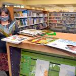 Jennifer Knight, youth services librarian at the Port Angeles Library, looks over a selection of books featured in Dolly Partons Imagination Library. (Keith Thorpe/Peninsula Daily News)