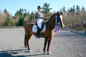 Jefferson County high school senior Emily Kilgore, on Antonio, is the first in the area to qualify to compete at the Interscholastic Equestrian Association’s National Dressage Finals this coming weekend in Texas. To up the competitive skill needed, riders compete on unfamiliar horses whose names they’ve drawn from a hat. (Karen Griffiths/for Peninsula Daily News)