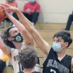 Keith Thorpe/Peninsula Daily News
Port Angeles' Dru Clark, left, looks for the hoop while fending off Klahowya's Drew Craft, right and Damon Clarke in the second half on Thursday at Port Angeles High School.