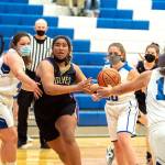 Steve Mullensky/for Peninsula Daily News

Sequim's Jelissa Julmist keeps her eyes on the basket as she drives for a score against East Jefferson's Alyssa Vandenberg, left, Shelby Theibelt, 30, and Gina Brown during a Saturday afternoon game played in Chimacum.