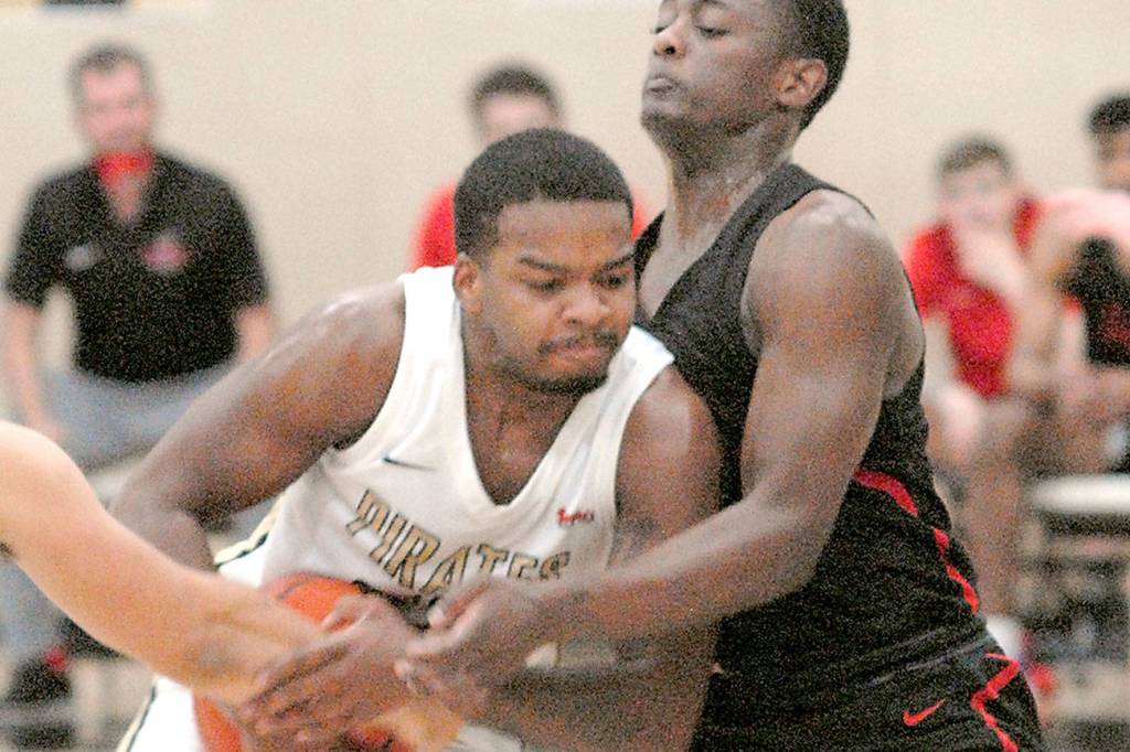 Keith Thorpe/Peninsula Daily News
Peninsula's Keith Seldon shoulders past Everett's Brycen Dillworth during the first half of Saturday's game in Port Angeles.