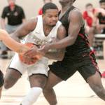 Keith Thorpe/Peninsula Daily News
Peninsula's Keith Seldon shoulders past Everett's Brycen Dillworth during the first half of Saturday's game in Port Angeles.