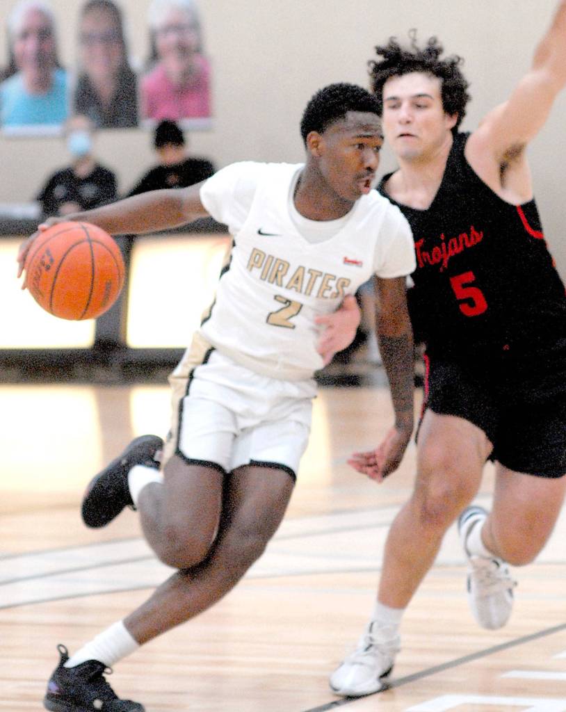 Keith Thorpe/Peninsula Daily News Peninsulas Marcus Rodgers, left, drives past Everetts Brayden Quantrille during Friday afternoons game at Peninsula College.