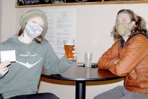 Rachel and Daniel Shyles were among nearly 30 people to attend a COVID-19 popup clinic at Barhop Brewing and Taproom for a free beer to go along with a free vaccine. Rachel got her second shot of Moderna vaccine on Saturday. Daniel said he already had two inoculations. The service was provided by the Clallam County Health and Human Services department. (Dave Logan/for Peninsula Daily News)