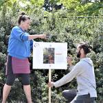 Katy Bowman and Michael Kaffel, instructors at Nutritious Movement in Sequim, practice staking panels for Sundays book walk at Finnriver Farm & Cidery in Chimacum. The mile-long walk is a free event featuring Bowmans new book, Grow Wild. (Diane Urbani de la Paz/Peninsula Daily News)