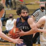 Keith Thorpe/Peninsula Daily News
Sequim's Tyler Mooney, center, drives to the lane flanked by Port Angeles' Tanner Price, left, and Michael Soule on Wednesday night in Port Angeles.