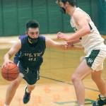 Sequims Jayden Possin, left, looks for a way around the defense of Port Angeles Wyatt Dunning on Wednesday night at Port Angeles High School. (Keith Thorpe/Peninsula Daily News)