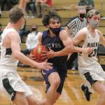 Sequims Tyler Mooney, center, drives to the lane flanked by Port Angeles Tanner Price, left, and Michael Soule on Wednesday night in Port Angeles. (Keith Thorpe/Peninsula Daily News)