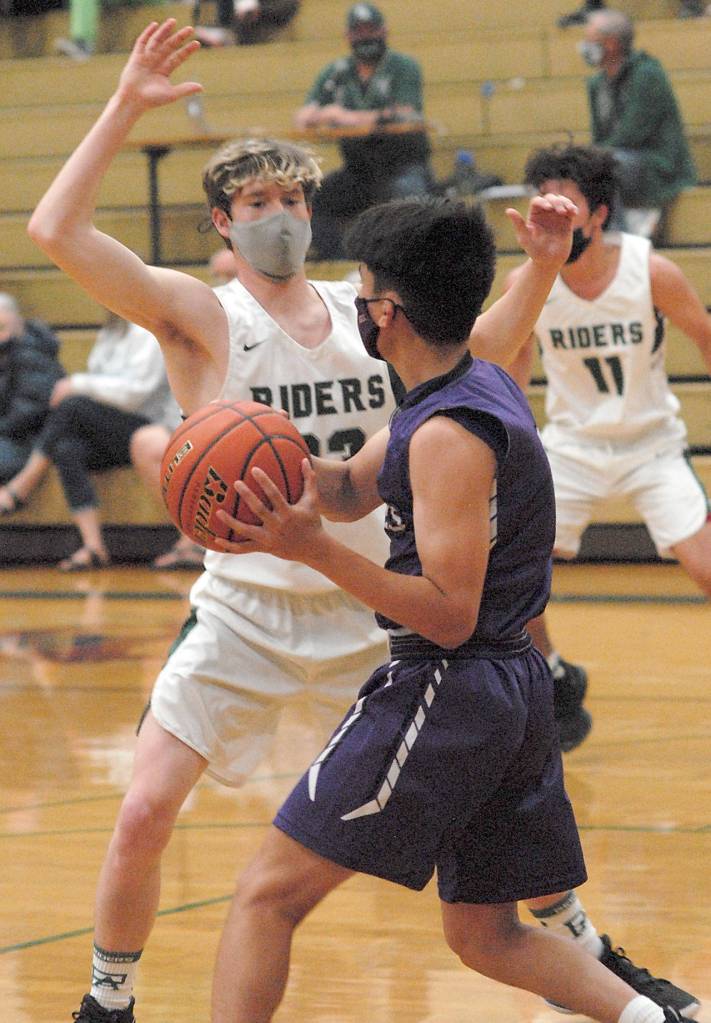 Port Angeles Michael Soule, left, blocks the progress of Sequims Krislian Mingoy as Soules teammate, Xander Maestas, looks on from across court on Wednesday night in Port Angeles. (Keith Thorpe/Peninsula Daily News)