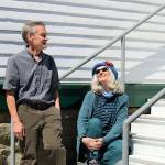 KPTZ-FM board president Robert Ambrose and general manager Kate Ingram take in the sun outside the radio station's new quarters at Fort Worden. The community station will move from Port Townsend's Mountain View Commons to the 2,500-square-foot Building 305 this summer. (Diane Urbani de la Paz/Peninsula Daily News)