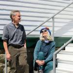 KPTZ-FM board president Robert Ambrose and general manager Kate Ingram take in the sun outside the radio stations new quarters at Fort Worden. The community station will move from Port Townsends Mountain View Commons to the 2,500-square-foot Building 305 this summer. (Diane Urbani de la Paz/Peninsula Daily News)