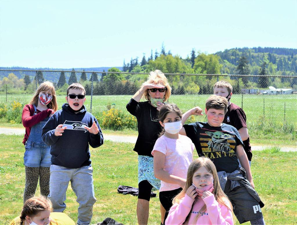 Chimacum Elementary School teacher Kit Pennell is happiest when surrounded by her students. They include, from left, Cora Van Otten, 9, McKenzee Bryant, 9, and Thomas Aumock, Mackenzie Almaden, Bella Van Ness, Brycen Christianson and Kam Taylor, all 10. (Diane Urbani de la Paz/Peninsula Daily News)