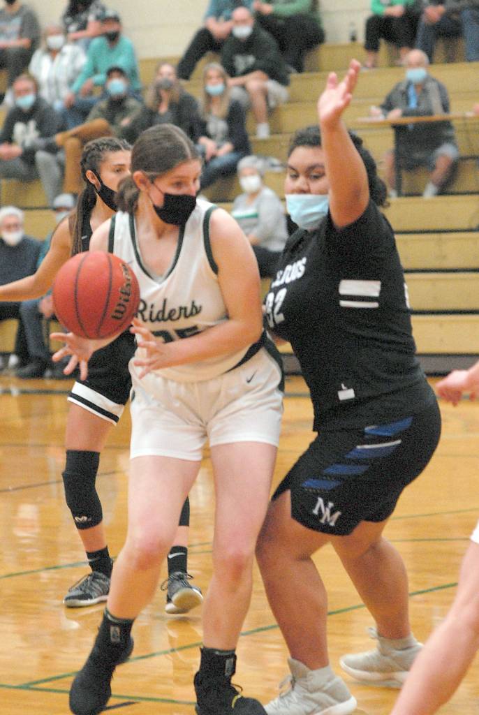 Keith Thorpe/Peninsula Daily News Port Angeles Ava Brenkman, left, evades the defense of North Masons Tanza Tupolo on Friday night in Port Angeles.