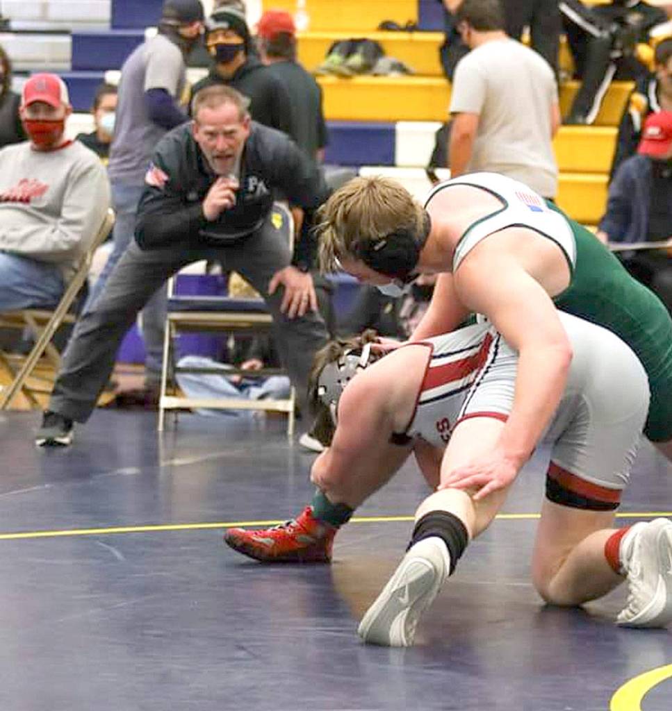 Port Angeles wrestling coach Rob Gale coaches Tom Arand during a match Saturday in Forks. (courtesy photo)