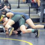 Forks Karen Ensastegui-Salazar (top) won by a pin over Faye Dahcs of Port Angeles in the 108- to 115-pound weight division. Ensastegui-Salazar ended up winning her weight division. (Lonnie Archibald/for Peninsula Daily News)