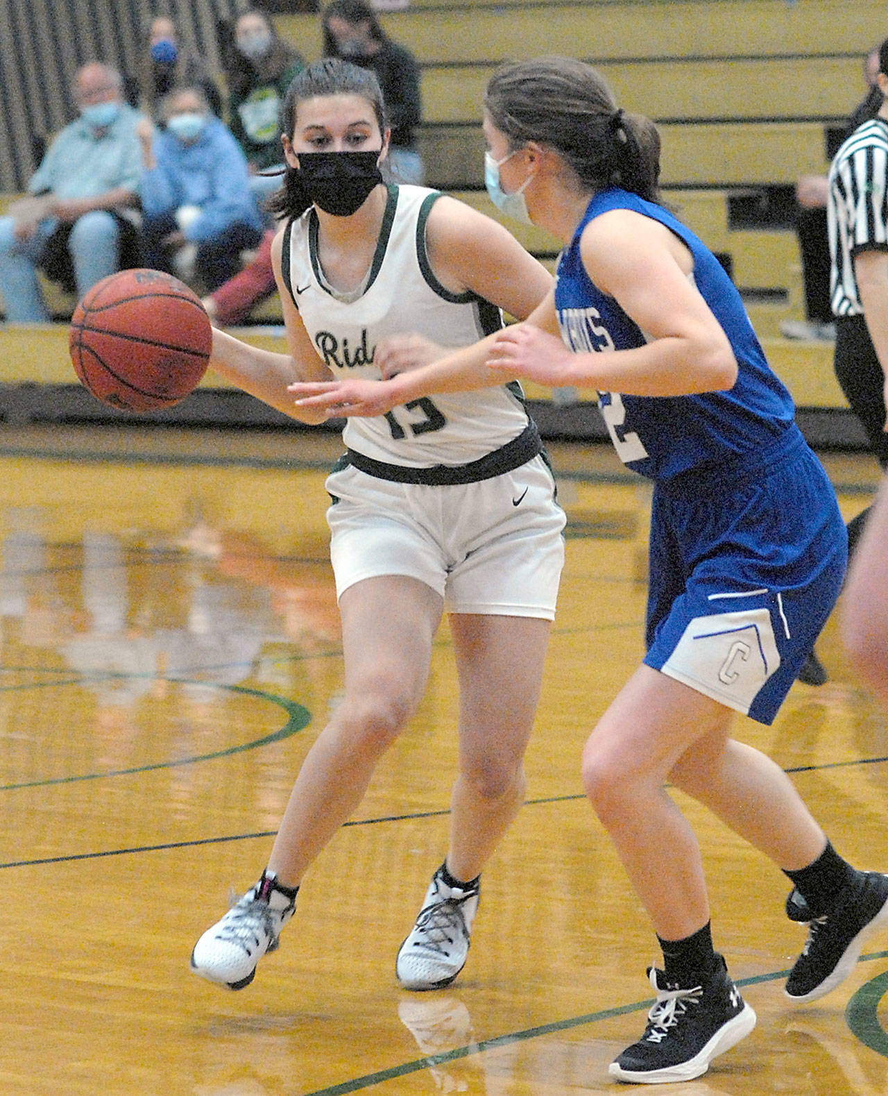 Port Angeles Bailee Larson, left, prepares to pass around the defense of East Jeffersons Aurin Asbell on Tuesday night at Port Angeles High School. (Keith Thorpe/Peninsula Daily News)