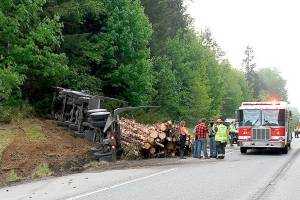 No one was injured when a log truck spilled its load after attempting to miss a car that turned in front of it. (Clallam County Fire District 2)