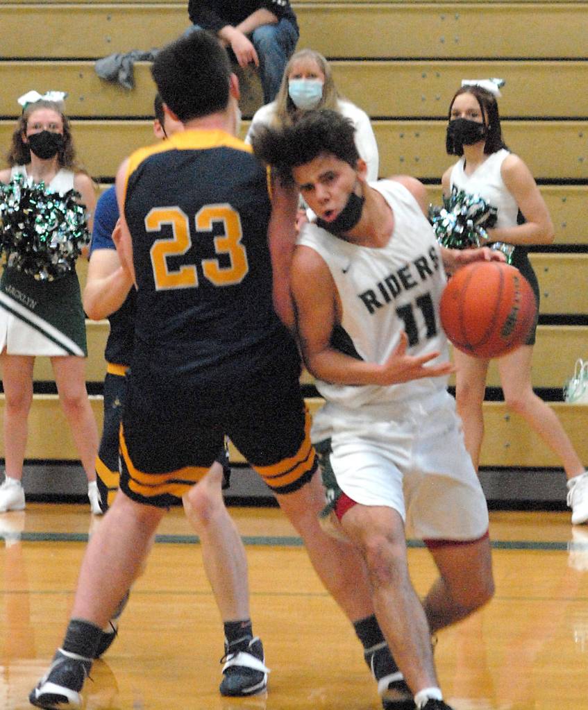 Keith Thorpe/Peninsula Daily News Port Angeles Xander Maestas, right, slides to the lane around Bainbridges James Carey during Thursday nights game in Port Angeles.