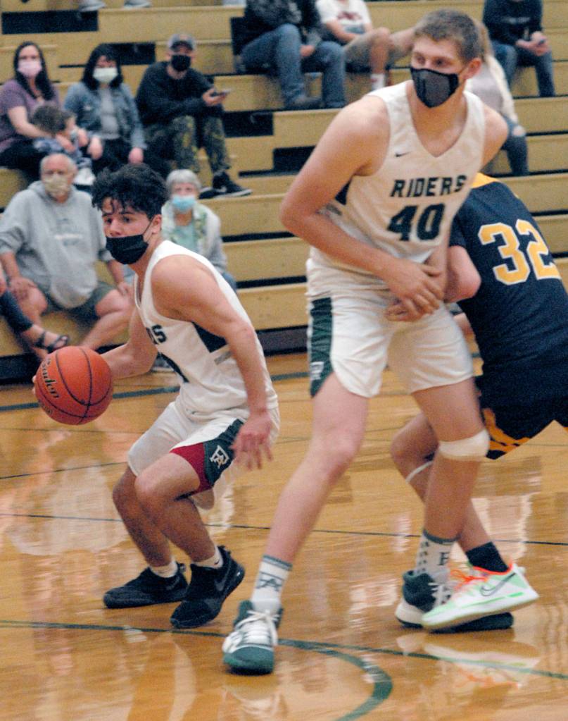 Keith Thorpe/Peninsula Daily News Port Angeles Xander Maestas, left, gets a screen from teammate John Vaara as Bainbridges Luke Lavigne, right, tries to get to the ball on Thursday in Port Angeles.