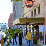 Movie lovers including Sandy Krist, foreground, stopped by the Rose Theatre in Port Townsend on Saturday afternoon to pick up their last bags of Rose-popped corn before the cinema reopens this summer. (Diane Urbani de la Paz/Peninsula Daily News)