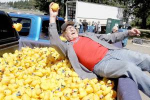 Ron Allen, CEO of the Jamestown SKlallam Tribe, has fun grabbing one of the 40 winning ducks for the Duck Derby on Sunday at Lincoln Park in Port Angeles. The tribe is one of the major sponsors of the event. (Dave Logan/for Peninsula Daily News)