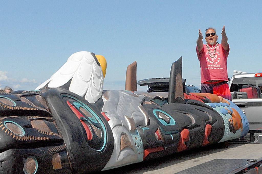 Phreddie Lane, Northwest road manager for the traveling Lummi Nation Sacred Sites Totem Pole, speaks to an assembled crowd at Port Angeles City Pier on Tuesday. (Keith Thorpe/Peninsula Daily News)