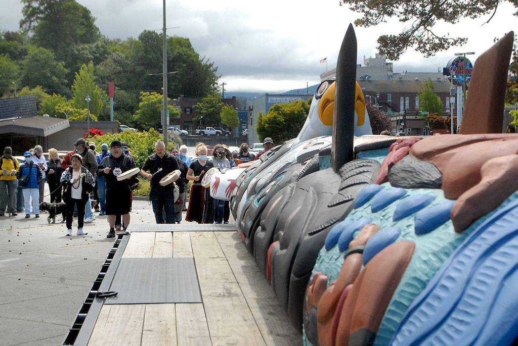 Drummers and singers greet a totem from the Lummi Nation after its arrival on Tuesday at Port Angeles City Pier. (Keith Thorpe/Peninsula Daily News)