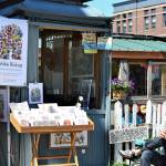 Artist Mike Biskup takes in the sun on Water Street in Port Townsend, where he sells his art from an antique elevator cage. (Diane Urbani de la Paz/Peninsula Daily News)