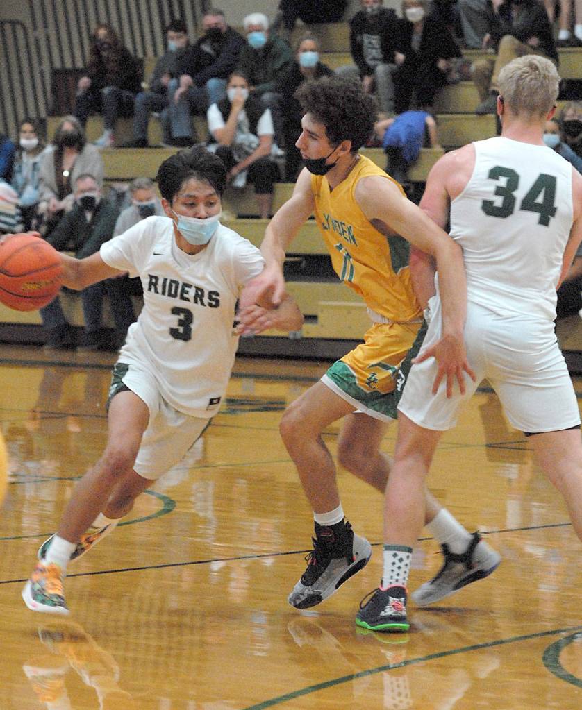 Keith Thorpe/Peninsula Daily News Port Angeles Quanah Wheeler, left, gets a block from teammate Adam Watkins, right, as he escapes the defense of Lyndens Jordan Medcalf on Friday at Port Angeles High School.