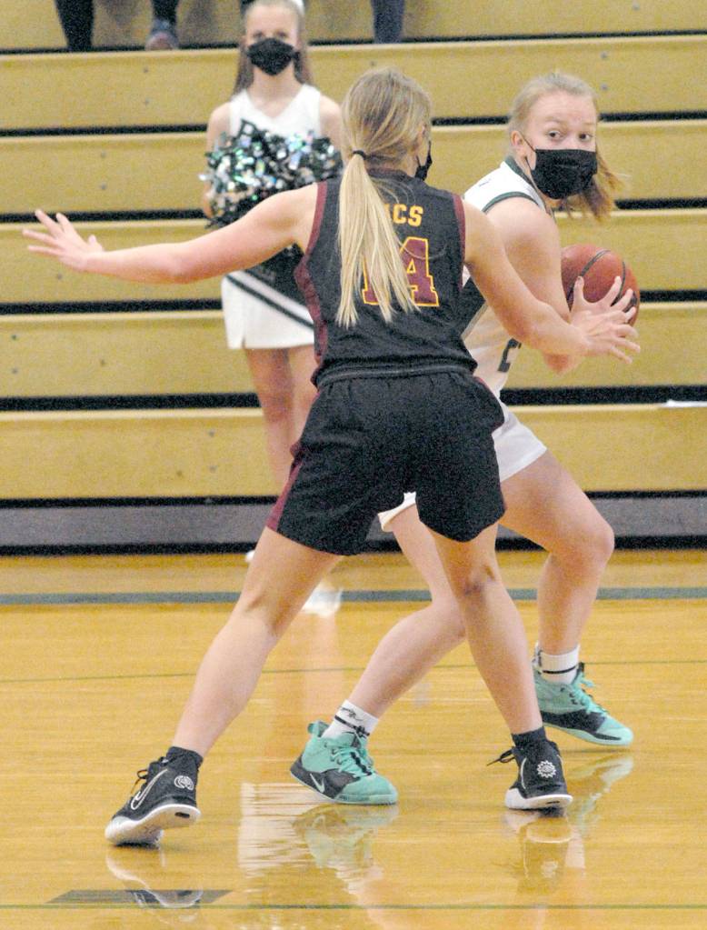 Keith Thorpe/Peninsula Daily News Port Angeles Anna Petty, right, tries to slip past the defense of Kingstons Sierra Denning on Friday at Port Angeles High School.