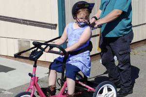 A Sequim students enjoys a ride on a newly-donated adaptive bicycle, donated by Rotary Club of Sequim. Submitted photo