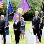Elks Lodge 317 members, from left, Mark Banks, trustee; Shirley Beck, leading knight; James Aman, loyal knight; and Greg Carroll, chaplain, stand in front of the Marvin Shields Post 26 American Legion color guard during a joint Memorial Day ceremony Monday at the Fort Worden Cemetery. Elks trustee David Crozier carried the Elks flag as part of the days color guard. (Zach Jablonski/Peninsula Daily News)