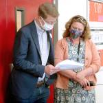 U.S. Rep. Derek Kilmer, left, looks over a copy of the Port Angeles School Districts 30-year plan with Roosevelt School principal Jennifer Van De Wege. (Keith Thorpe/Peninsula Daily News)
