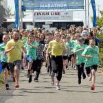 Youngsters accompanied by a pair of pace runners take off down the Waterfront Trail portion of the Olympic Discovery Trail from Port Angeles City Pier during the 2019 North Olympic Discovery Marathon Kid's Marathon. (Keith Thorpe/Peninsula Daily News)
