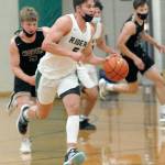 Keith Thorpe/Peninsula Daily News Port Angeles Chase Cobb drives down court pursued by North Kitsaps Colton Bower, left, and Jack Ryan, right, and teammate Jeremiah Hall on Thursday at Port Angeles High School.