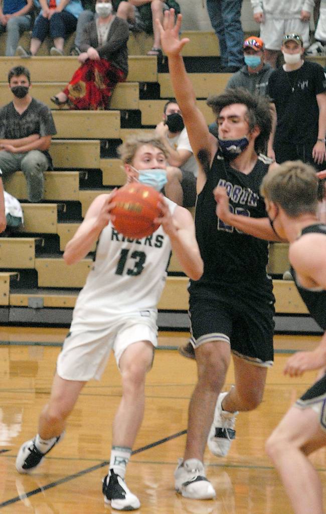 Keith Thorpe/Peninsula Daily News Port Angeles Tanner Price, left, is defended by North Kitsaps Dalton Brockett on Thursday night in Port Angeles.