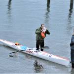 With Northwest Maritime Center staff and volunteers welcoming him to the beach, Seventy48 winner Carter Johnson gets a long-awaited drink of water. (Diane Urbani de la Paz/Peninsula Daily News)