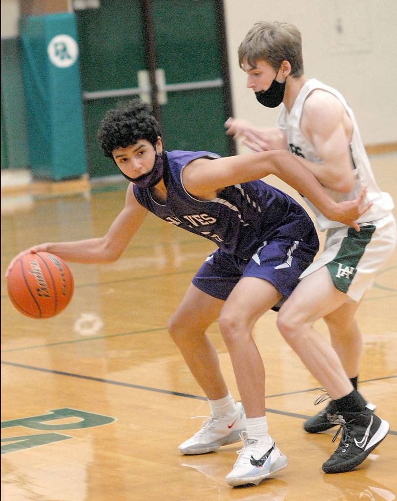 Keith Thorpe/Peninsula Daily News Sequims Aaron Bess, left, tries to evade Port Angeles Josiah Long on during Saturdays playoff game in Port Angeles.