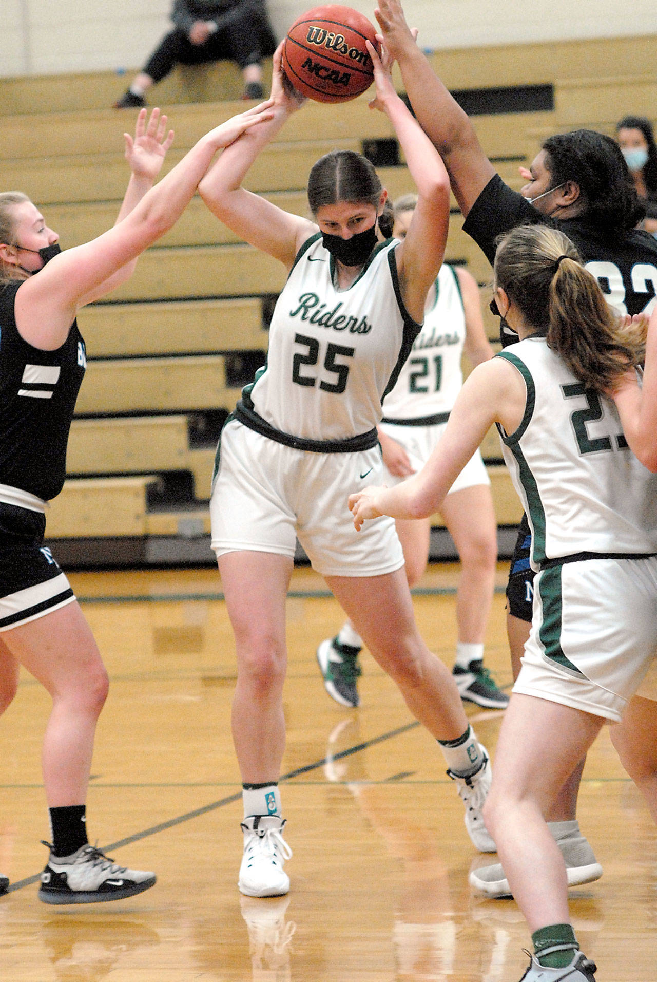 Keith Thorpe/Peninsula Daily News Port Angeles Ava Brenkman, center, fends of the defense of North Masons Tessa Griffey, left, and Tanza Tupolo, right, as Brenkmans teammate, Bergen Shamp, tries to assist on Saturday in Port Angeles.