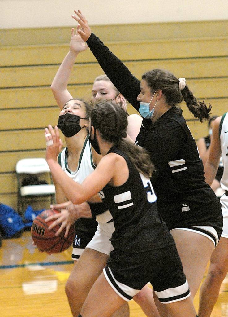 Keith Thodrpe/Peninsula Daily News Port Angeles Eve Burke, center, finds herself surrounded by North Mason defenders from back, Tessa Griffey, Jillian Maiuri and Rachel Youngman on Saturday in Port Angeles.
