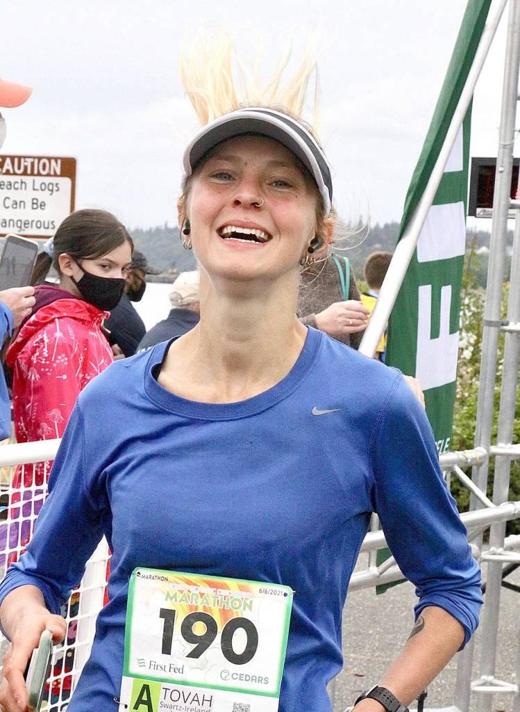 The womens marathon winner, Tovah Swartz-Ireland of Bellingham, crosses the finish line at the North Olympic Discovery Marathon on Sunday. (Dave Logan/for Peninsula Daily News)