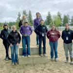 Sequim and Port Angeles high school equestrian teams take a break at the Washington High School Equestrian Team District 4's third and final meet in Elma before state finals. They are bottom row, from left, Haley Bishop (PA), Katie Marchant (PA), Libby Swanberg (S), Keri Tucker (S), Sydney Hutton (PA), Abby Garcia (S), Sara Holland (PA) and Amelia Kinney (PA); top row, from left, Susannah Sharp (S) and Rainey Bronsink (S). (Photo courtesy of Katie Newton)