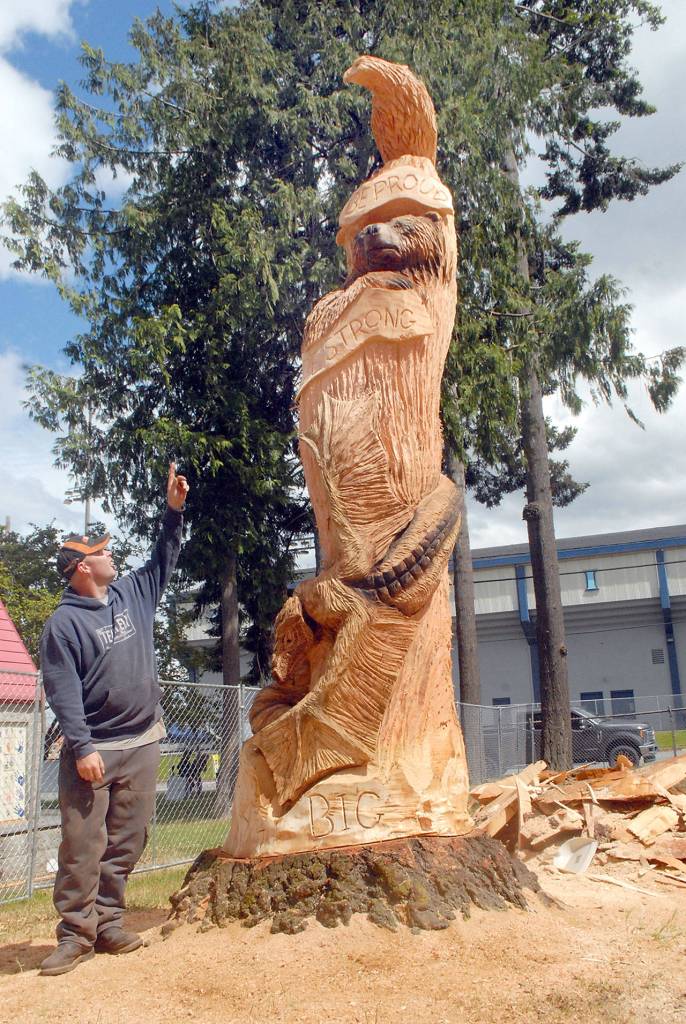 Keith Thorpe/Peninsula Daily News
Carver Nick Bielby of Nicklby Wood Carving points out features of his wood sculpture under construction at the Generation II Dream Playground at Erickson Playfield in Port Angeles.