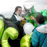 Rikki Ann Sandberg gets assistance from her aunt, Valerie Sandberg, as she gets ready to ride in Fridays Senior Parade for graduating seniors of Port Angeles High School. (Keith Thorpe/Peninsula Daily News)
