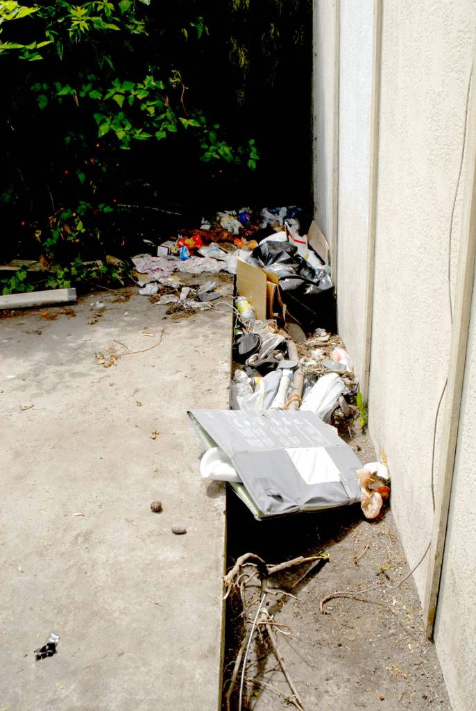 Piles of refuse sit next to an empty building in the 200 block of East Front Street in Port Angeles on Thursday. (Keith Thorpe/Peninsula Daily News)