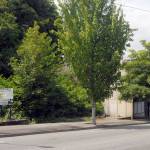 A pair of vacant building pads, once surrounded by fencing, stand next to an unoccupied building on Front Street near Lincoln Street at the entry to downtown Port Angeles. (Keith Thorpe/Peninsua Daily News)