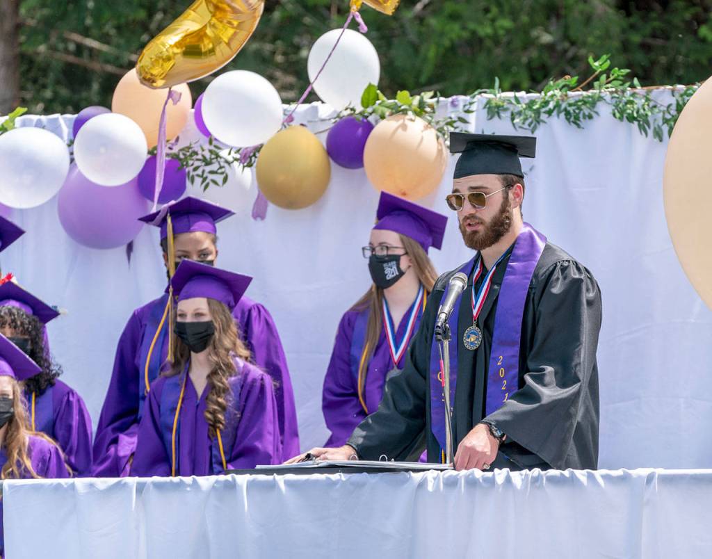 Quilcene High School Valedictorian Zach Budnek gives an address to his fellow graduates during an commencement exercise Saturday at the high school. (Steve Mullensky/for Peninsula Daily News)