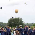 Caps were tossed and balloons released after the presentation of the Forks High School Class of 2021 on Saturday. (Lonnie Archibald/for Peninsula Daily News)