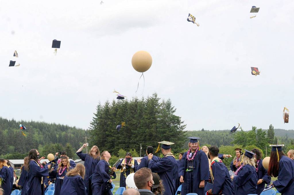 Caps were tossed and balloons released after the presentation of the Forks High School Class of 2021 on Saturday. (Lonnie Archibald/for Peninsula Daily News)